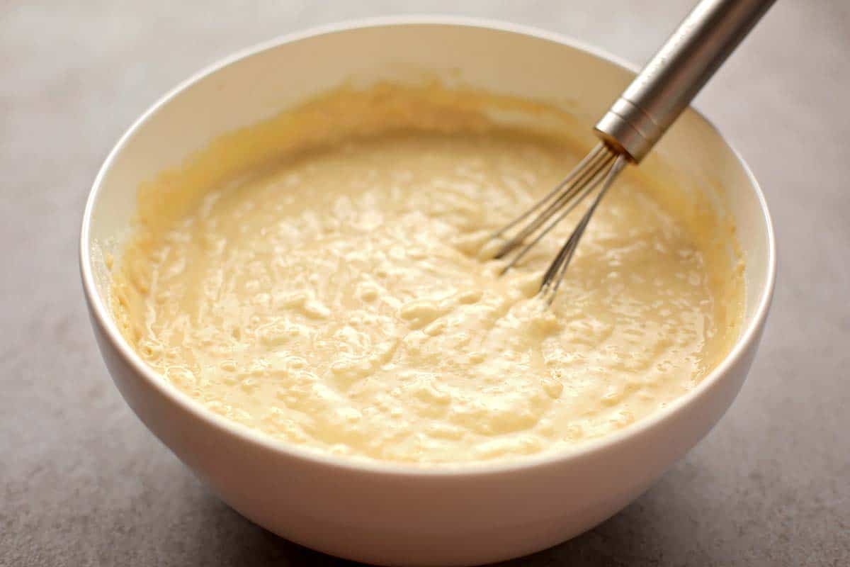 white mixing bowl with batter for pancakes