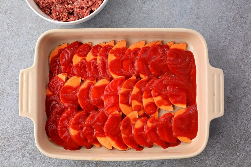 layered sweet potatoes in the casserole dish