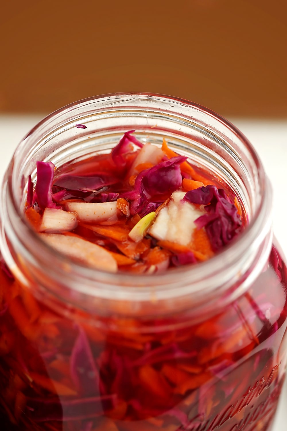 jar filled with pickled cabbage with carrots slaw