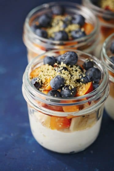 mason jars with cottage cheese, peaches and blueberries
