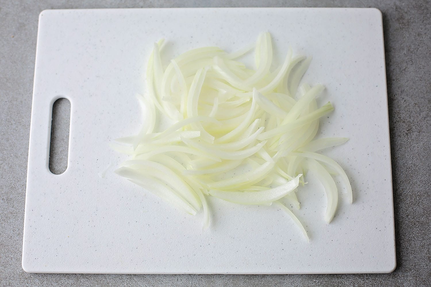 sliced onion on the white cutting board