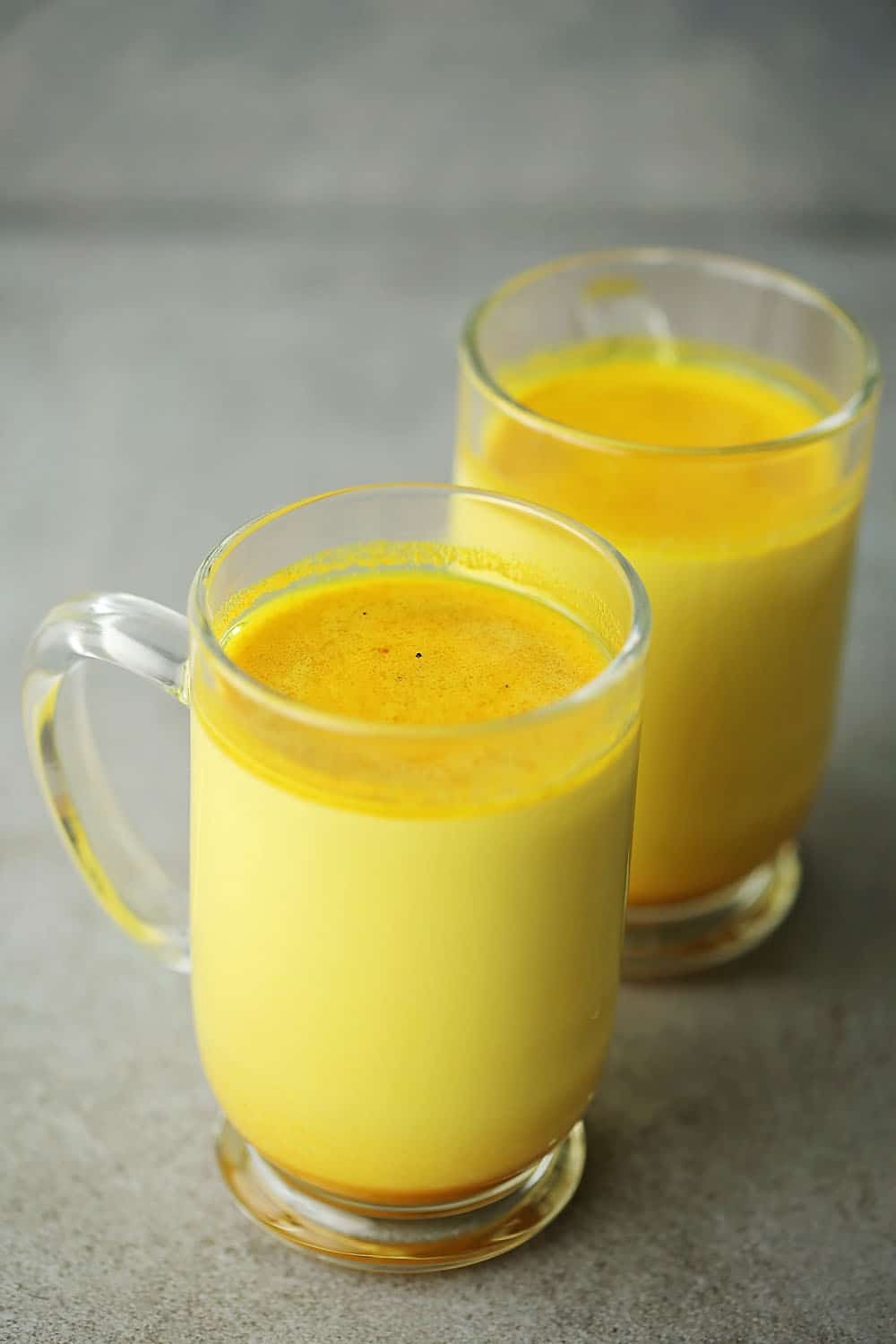 two glass cups with turmeric milk