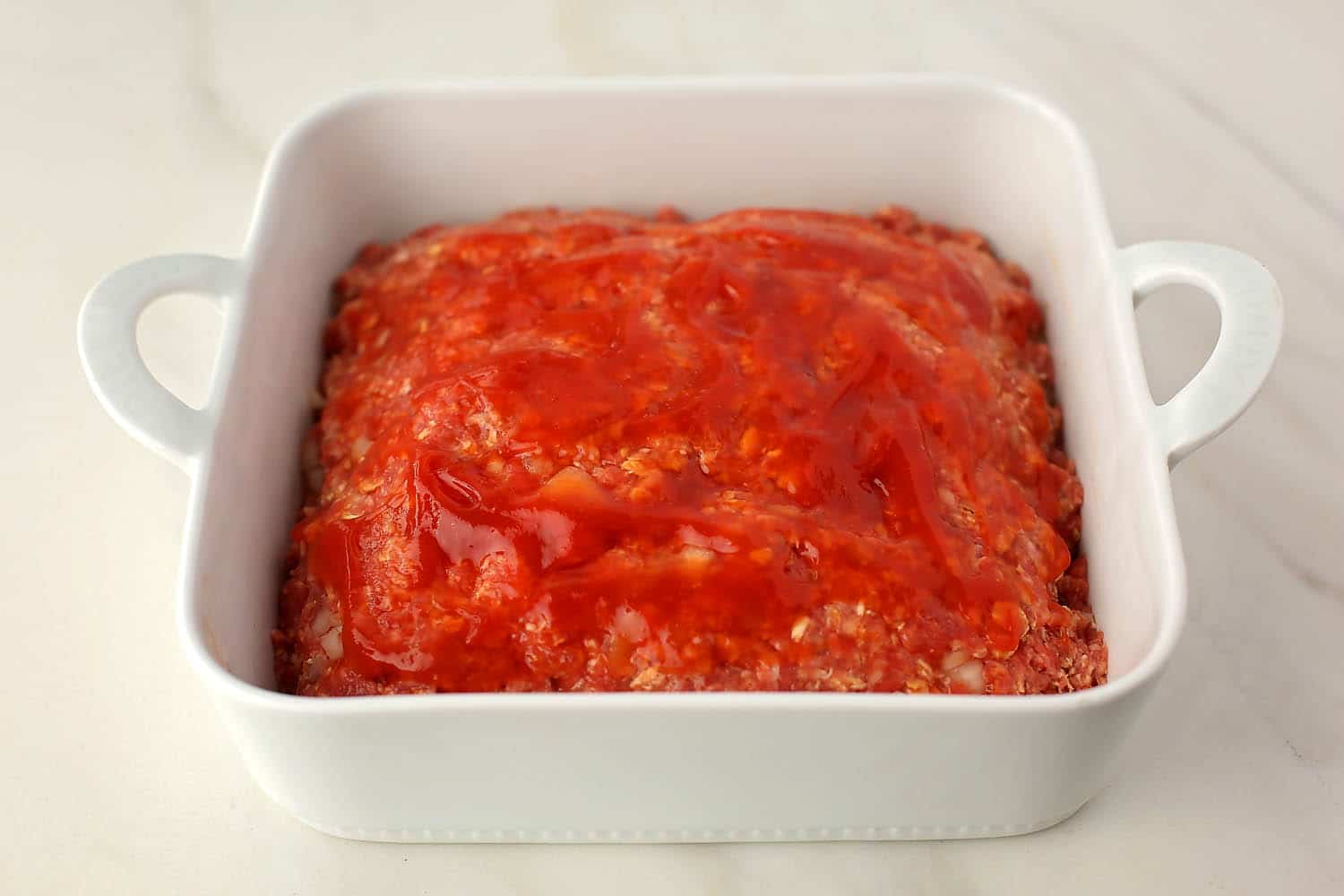 baking dish with meatloaf before going inside the oven