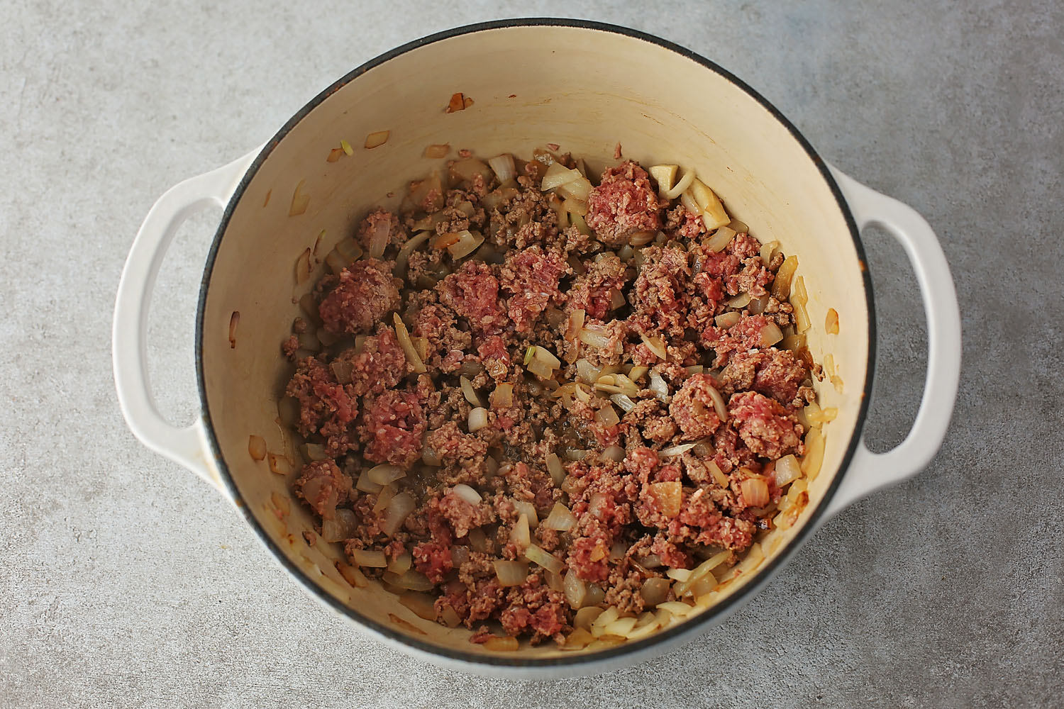 pot with sauteed onions and ground beef