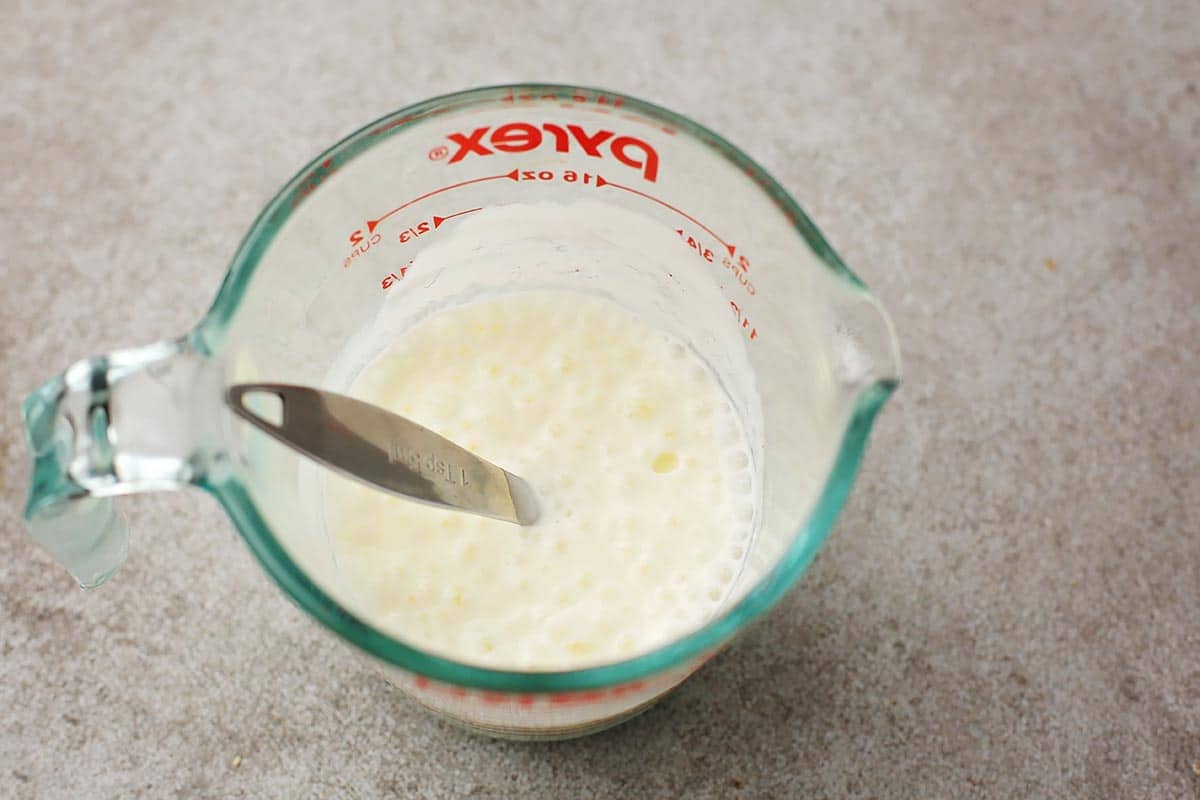 measuring cup with white kefir
