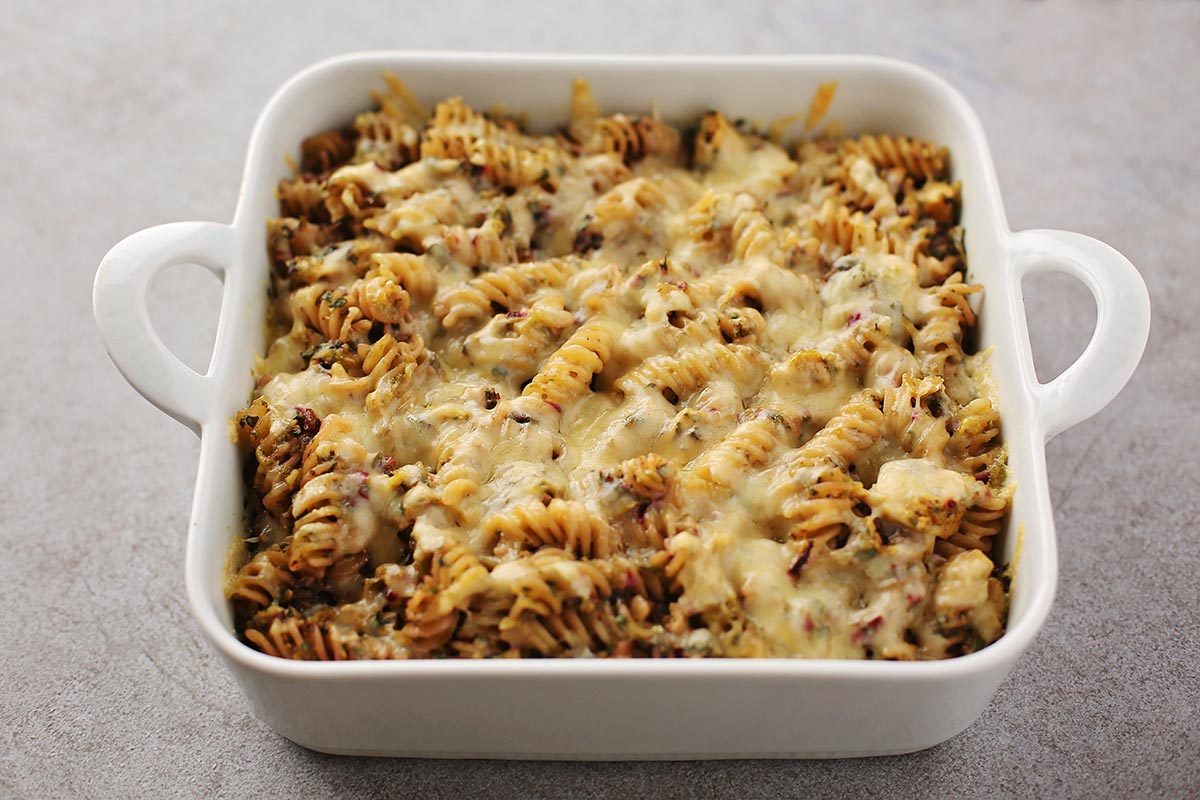 white baking dish with baked yellow cheesy casserole
