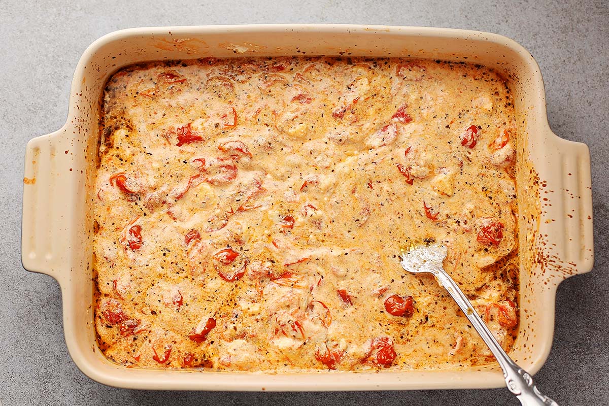 dish with mixed white creamy cheese and roasted tomatoes