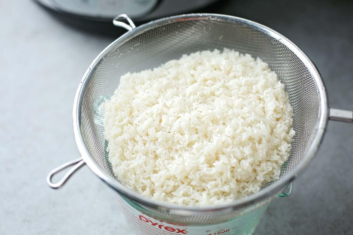 rinsed white rice in the mesh strainer