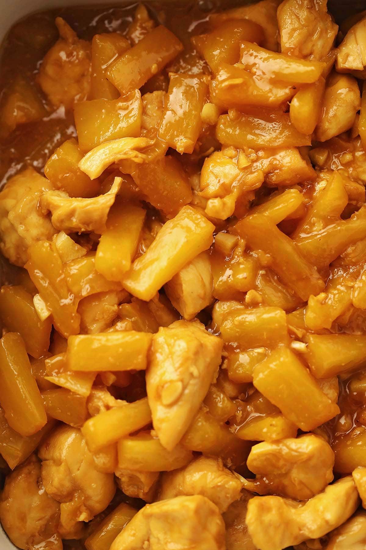 close up image of the cooked chicken with pineapple inside instant pot
