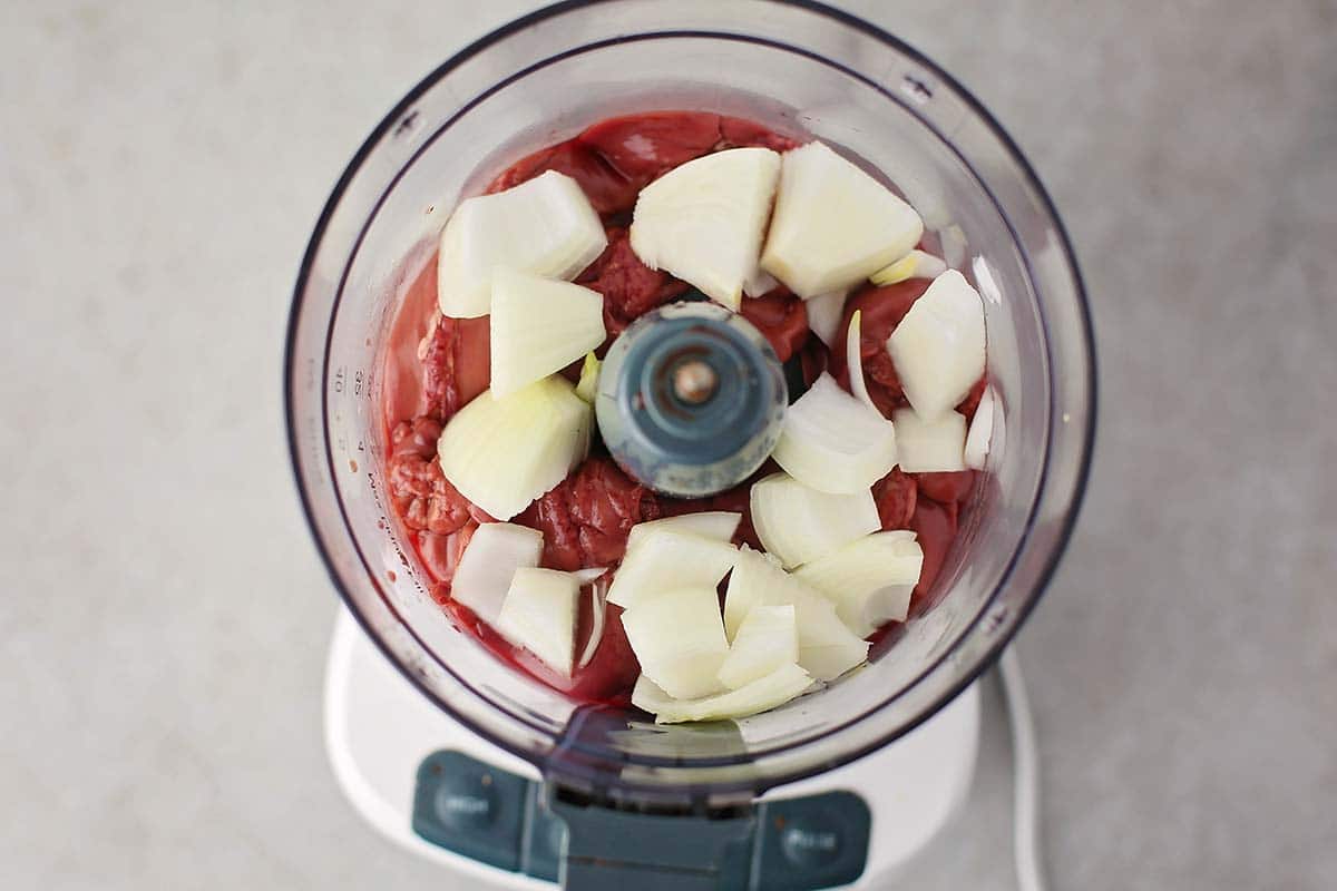 food processor with ground meat and onions