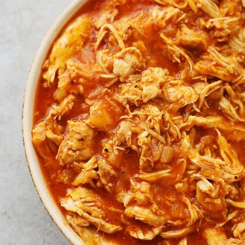 plate filled with shredded chicken in BBQ sauce