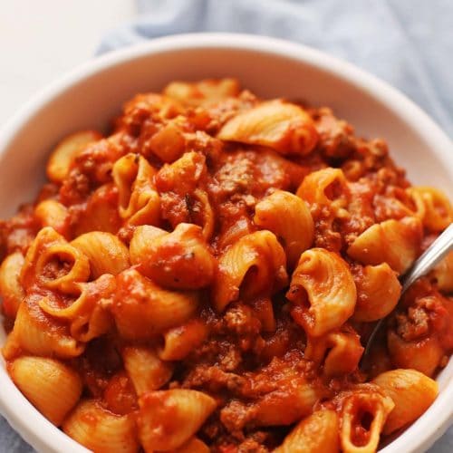 white bowl filled with pasta in red sauce