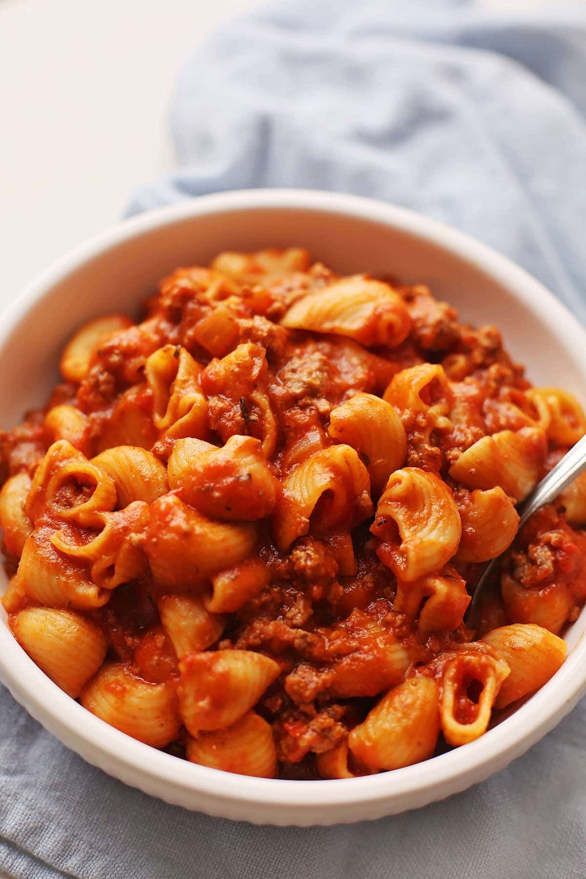 white bowl filled with pasta in red sauce