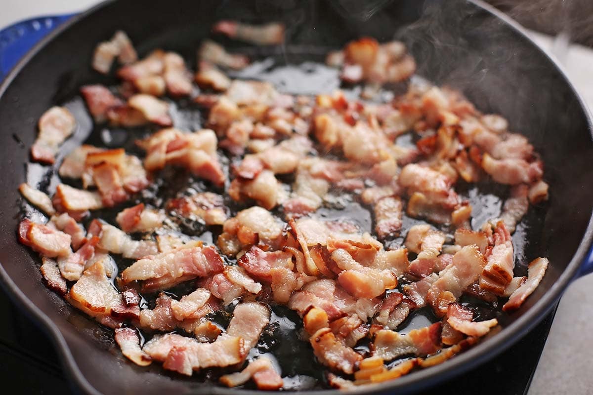 cast iron skillet with fried bacon