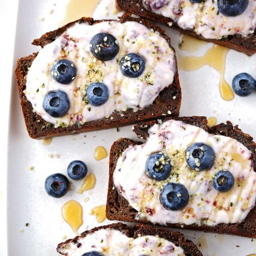 slices of banana bread topped with yogurt and berries