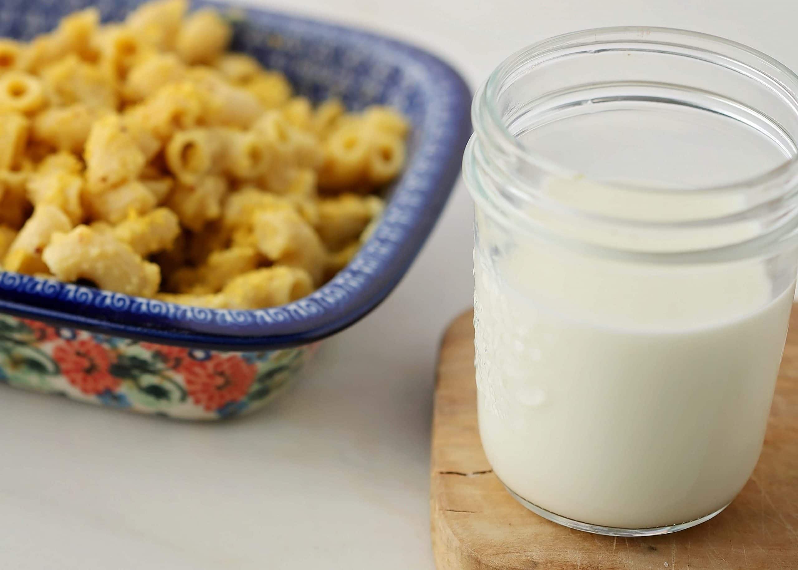 jar with milk next to dish with mac and cheese