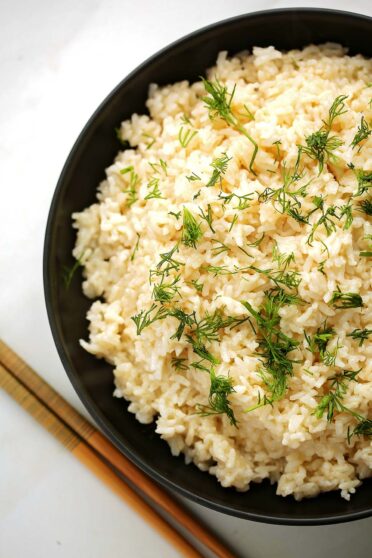 black plate filled with white fluffy rice