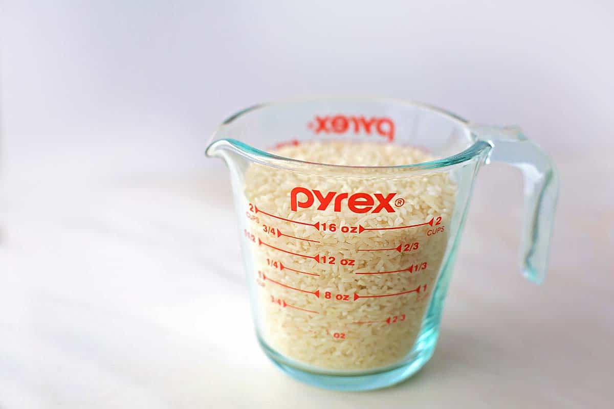 white counter with measuring cup with rice