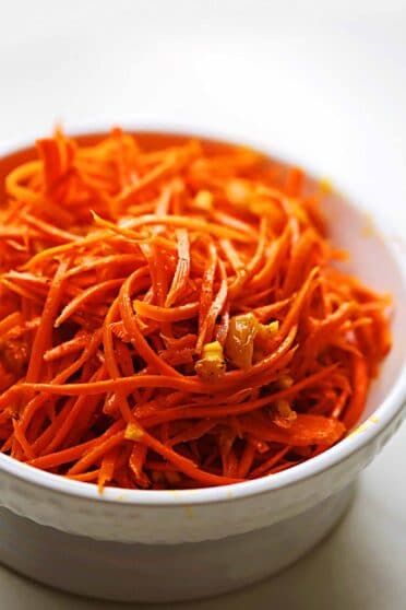 white serving bowl with grated carrots