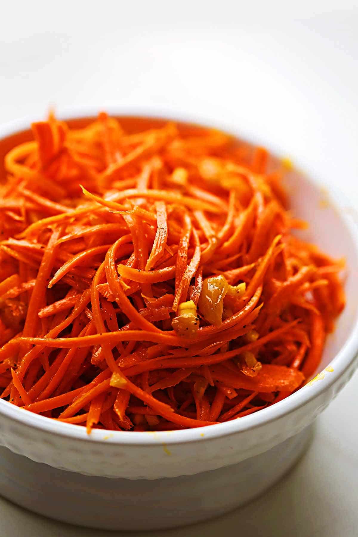 white bowl with grated carrots and spices