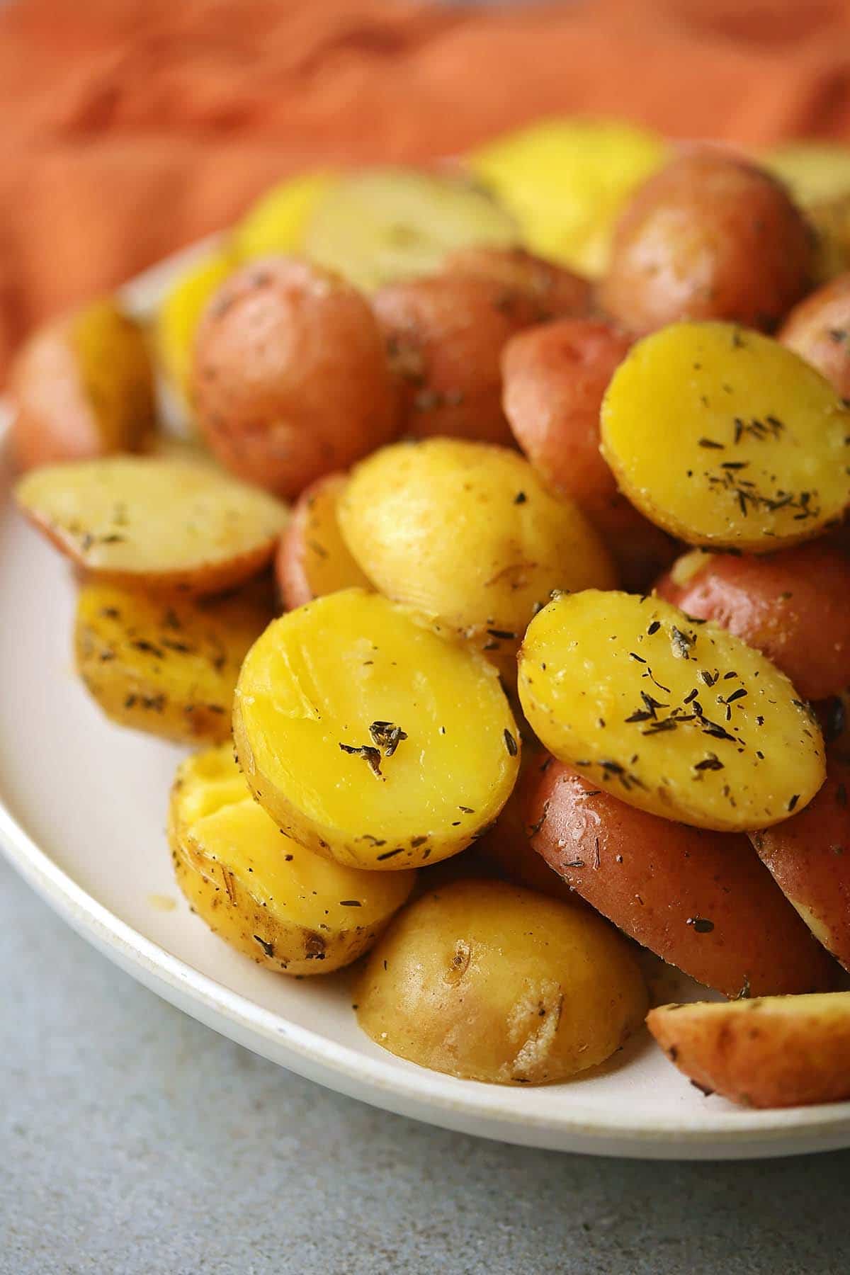 macro shot of cooked baby potatoes with herbs and spices