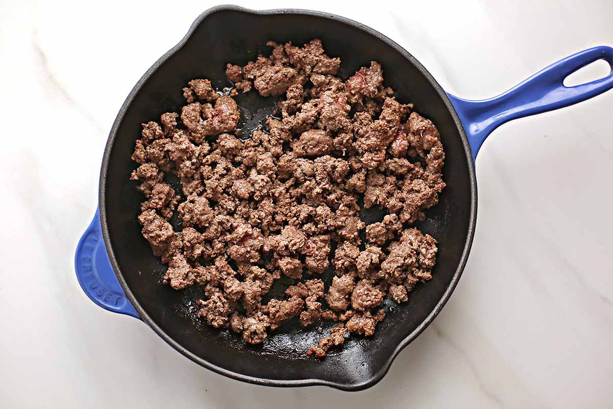 cast iron skillet with cooked ground beef