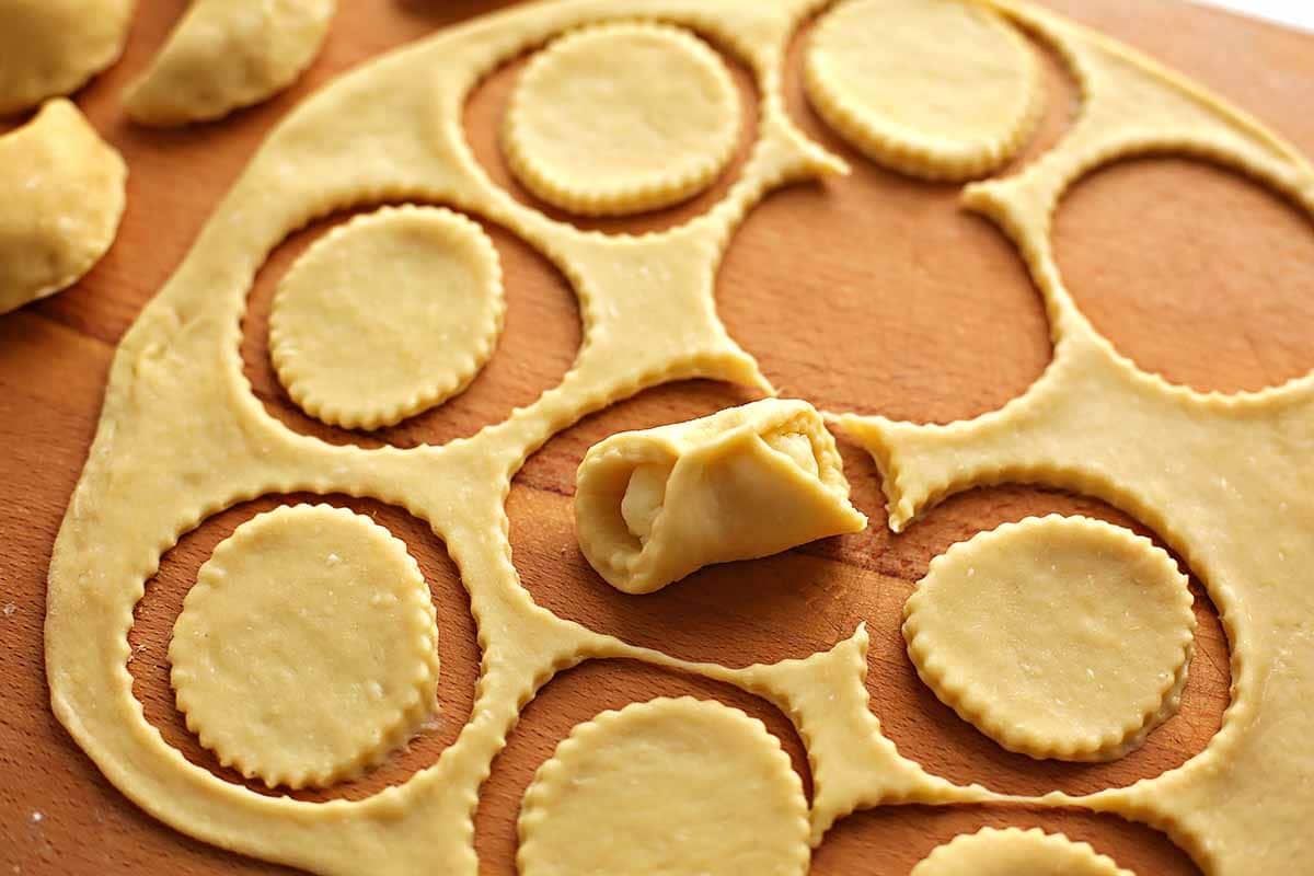 the process of making homemade vareniki, cut out circle with potato filling in the middle