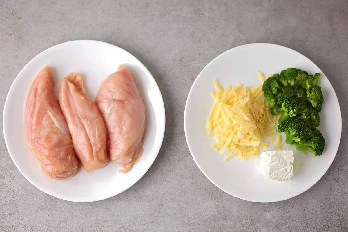 two plates with ingredients to make stuffed chicken breast: raw chicken breast, broccoli, cheese, goat cheese