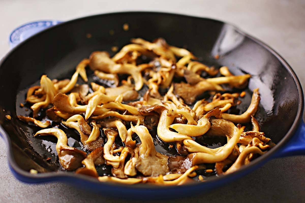 skillet with cooked oyster mushrooms with butter