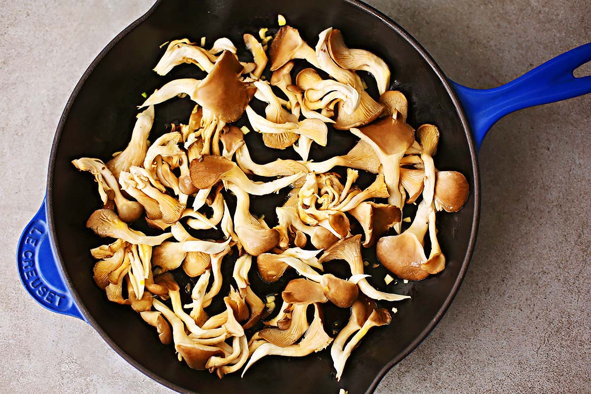 skillet with uncooked oyster mushrooms