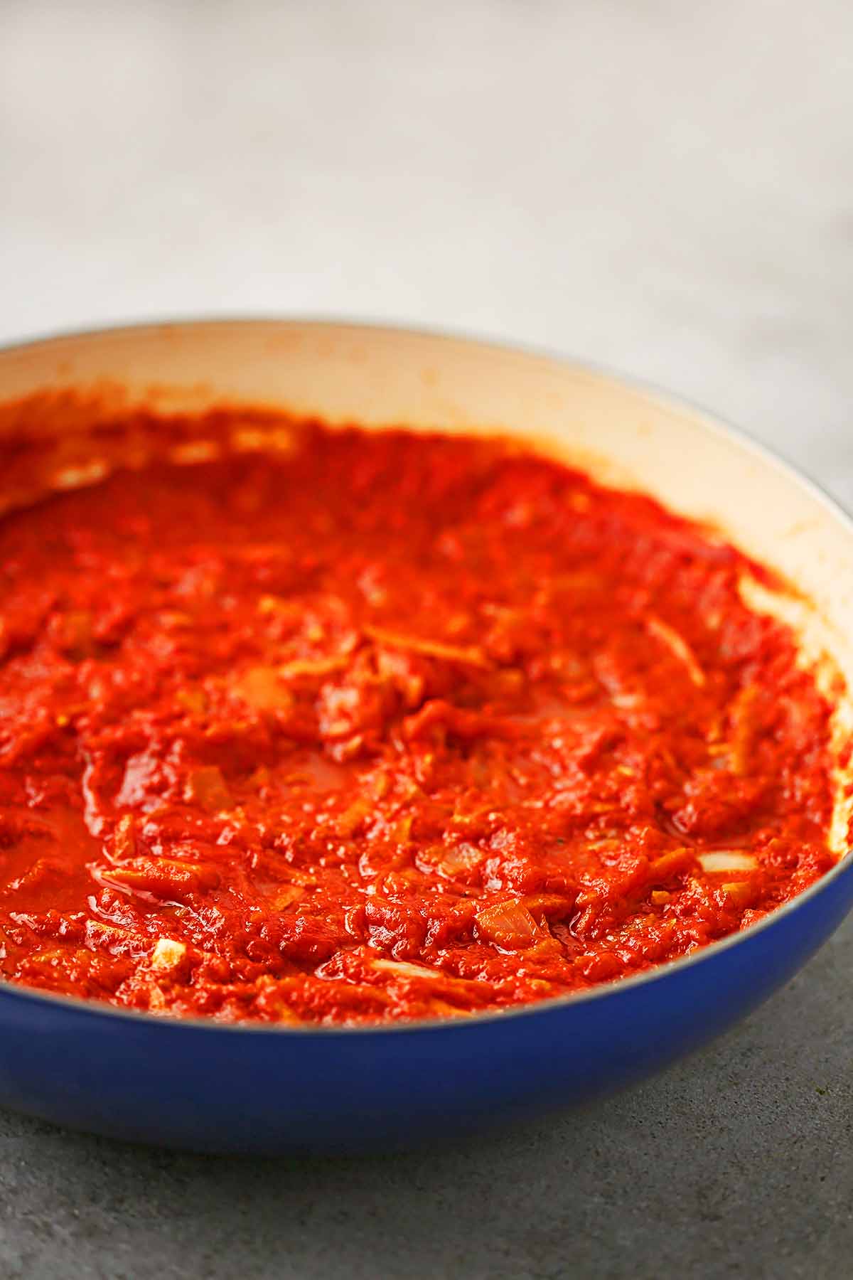 large skillet filled with bright red thick sauce