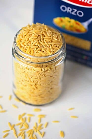 glass jar filled with uncooked orzo pasta