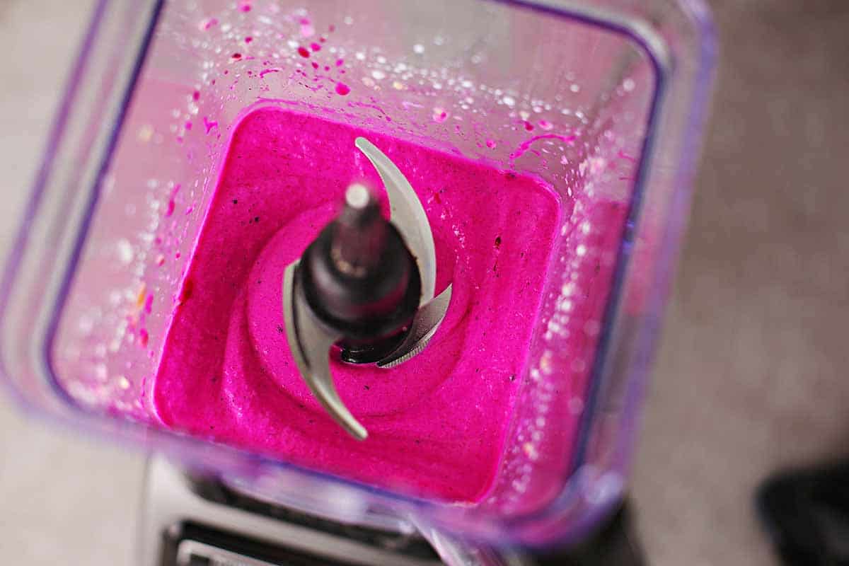 blender with blended bright pink pitaya fruit