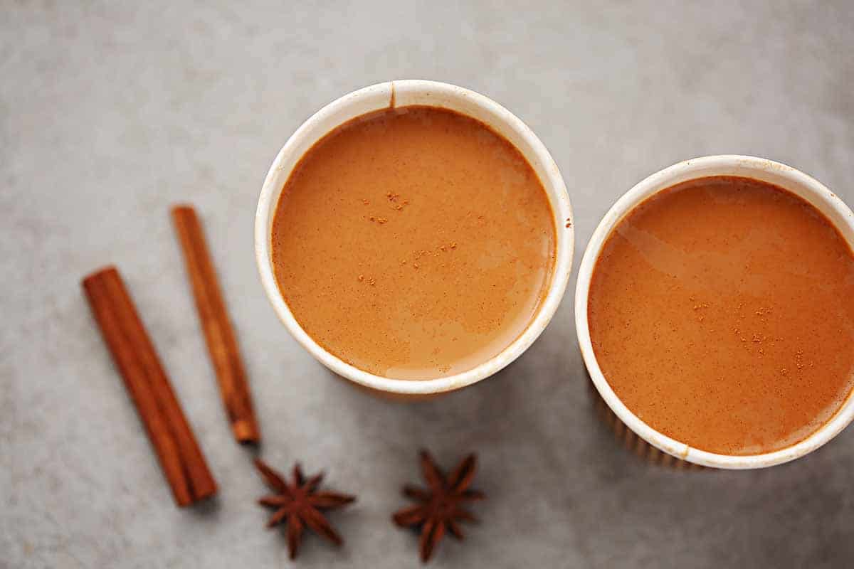 two cups filled with chai drink 