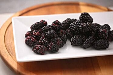 plate filled with mulberry and blackberry