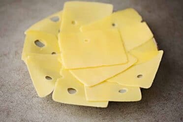 sliced swiss cheese arranged on the plate