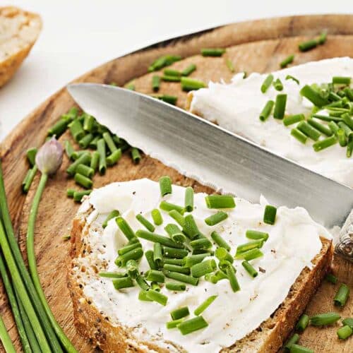 Toasts with boursin cheese on top, garnished with greens.