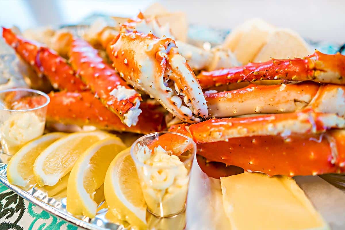 Cooked crab served with butter and sliced lemon