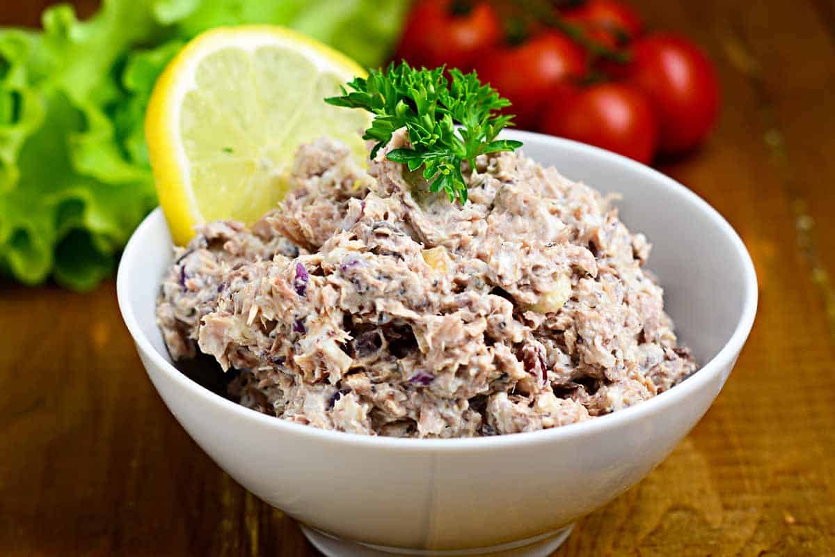 White bowl filled with tuna salad. 