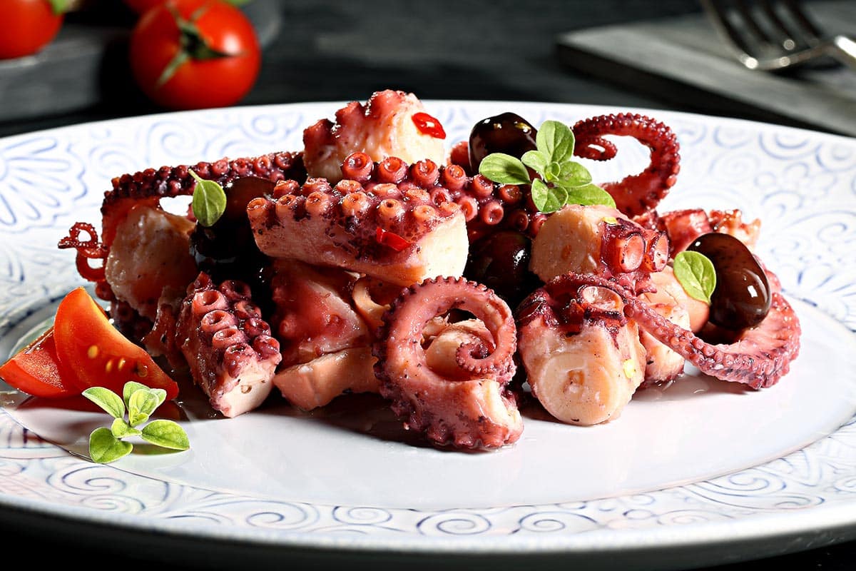 white plate with with cooked octopus. 