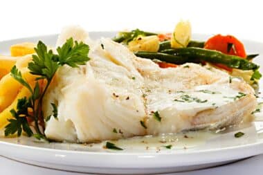 White plate served with cooked halibut