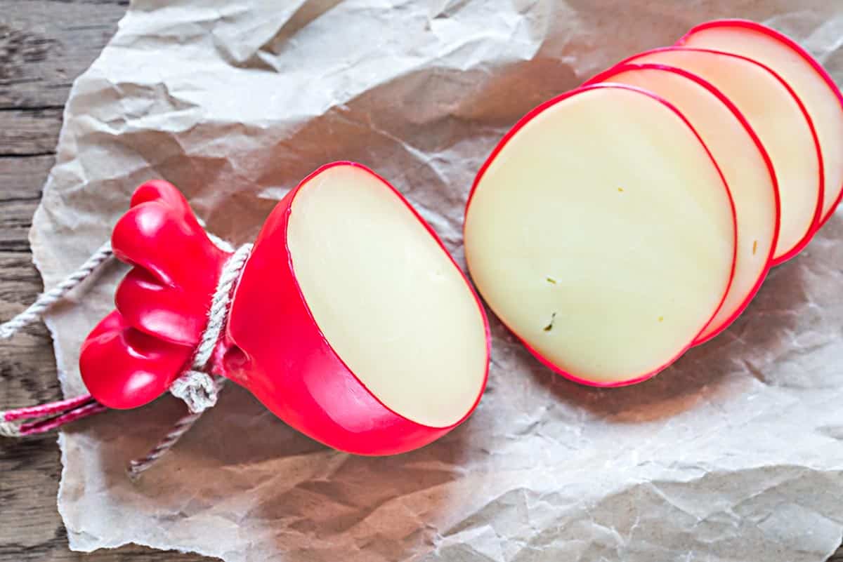 sliced provolone cheese on top of parchment paper. 