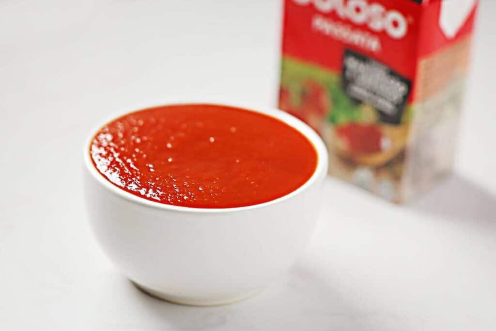 Bowl with spicy tomato paste on the white background. 