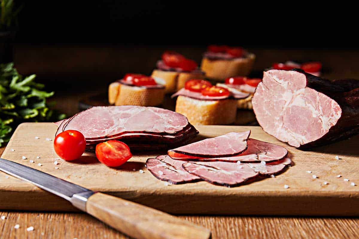 Wooden board served with sliced turkey bacon. 