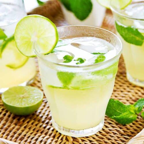Glass filled with lime juice and decorated with lime slices.