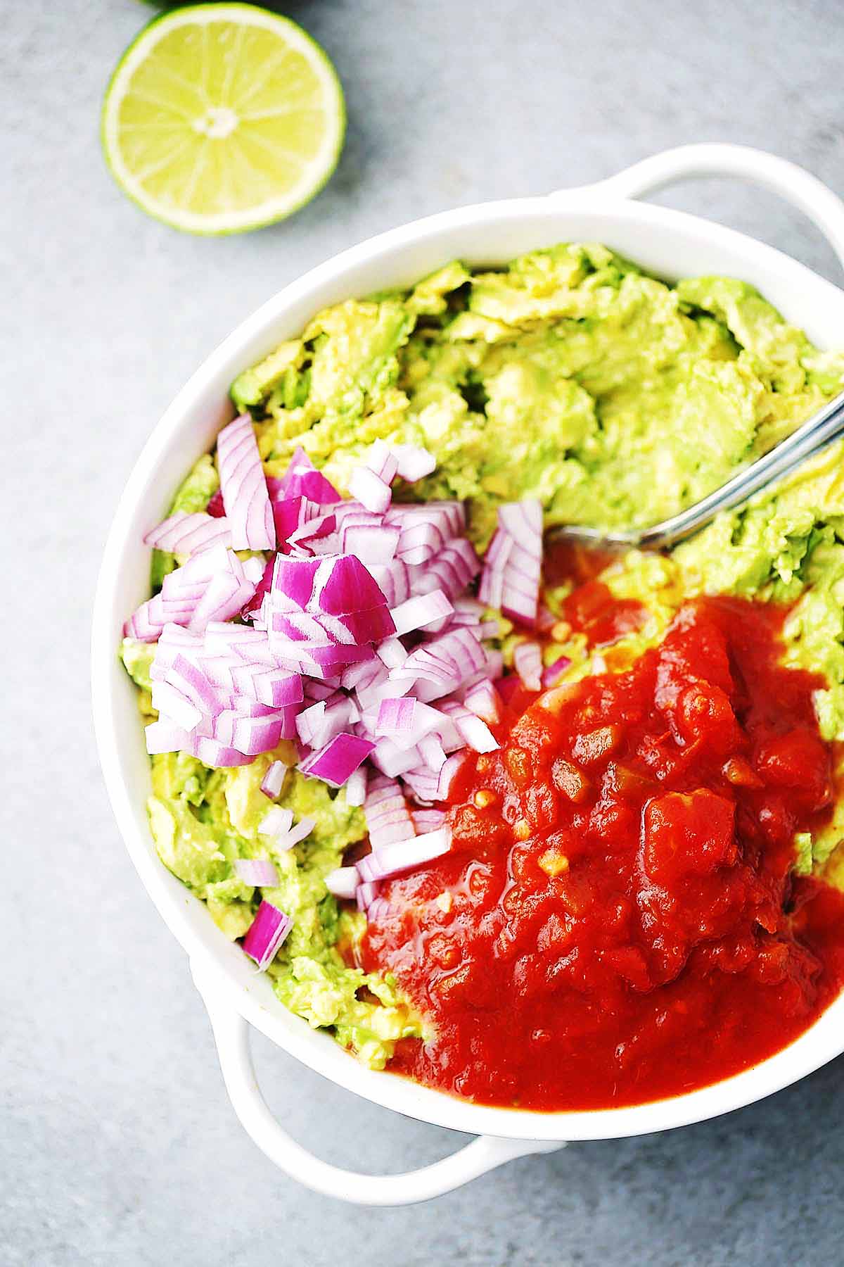 Dish with guacamole ingredients.