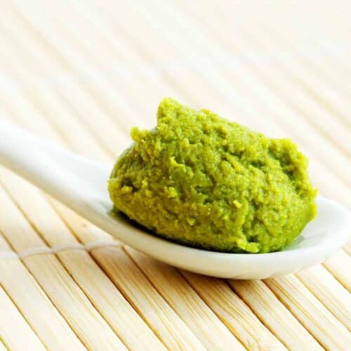 White scoop served with green wasabi sauce.