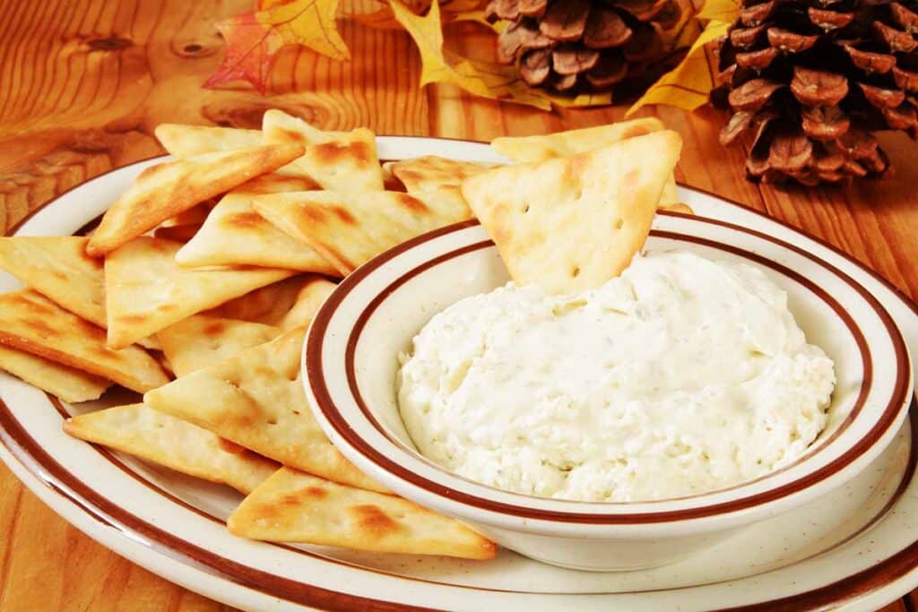 Plate with pita crackers and white dip. 