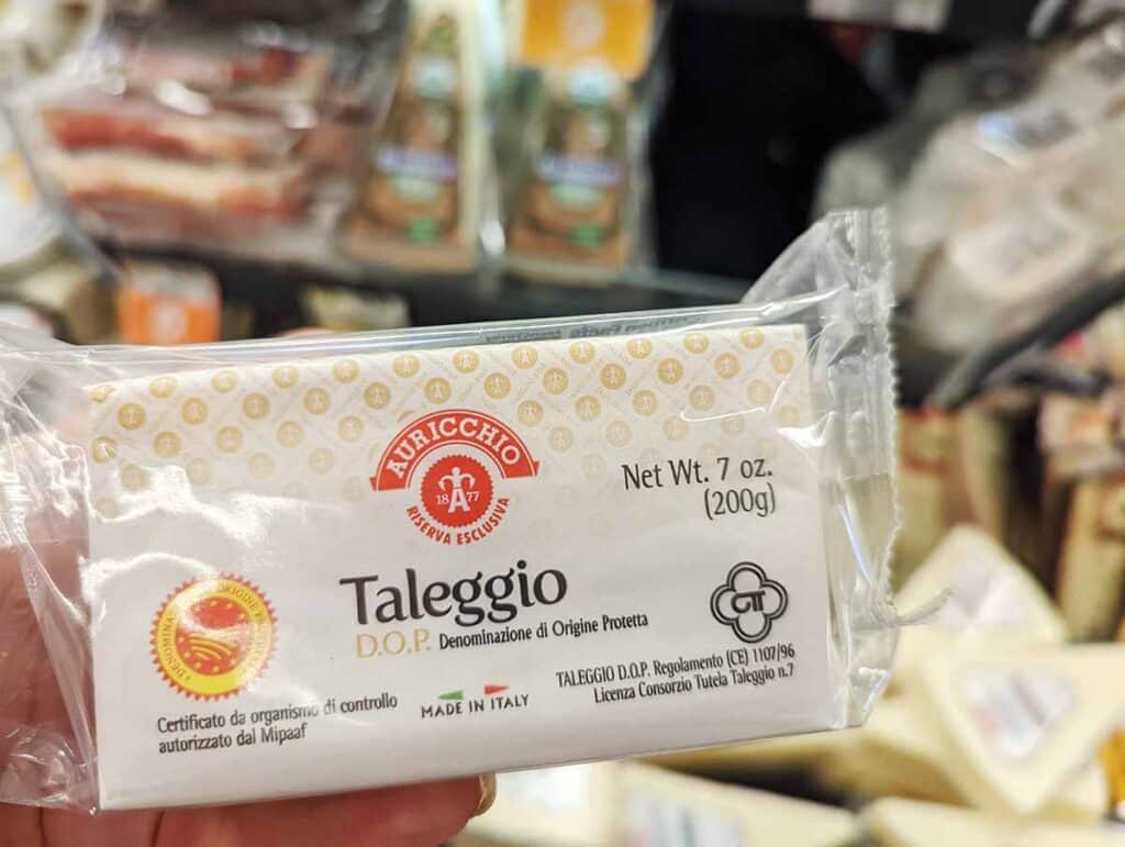 Package with Taleggio cheese at the grocery store. 
