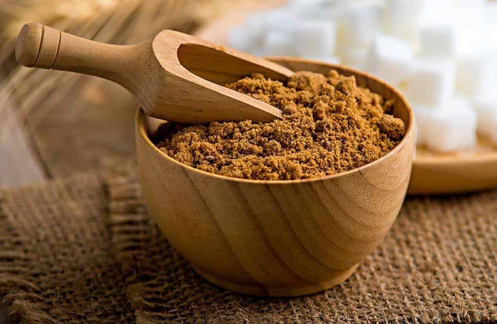 Bowl and scoop filled with ground allspice. 